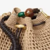 Geantă de umăr Cinch Medium din rafie croșetată în culori naturale și ciocolatiu, cu curea împletită Geantă de umăr Cinch Medium din rafie croșetată în culori naturale și ciocolatiu, cu curea împletită
