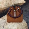 Geantă tip sac Bon Bon din piele de căprioară maro deschis, cu închizătoare cu mărgele și mâner din coajă de broască țestoasă